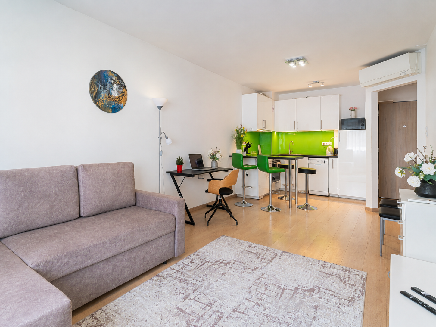 Maria’s Budapest living room with sofa, dedicated workspace and open kitchen
